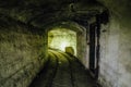 An abandoned warship ammunition transport tunnel with the remains of a narrow gauge railway Royalty Free Stock Photo