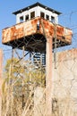 Abandoned watch-tower and prison fence wire barbs