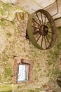 Abandoned water mill. Rusty wheels and green moss covered the old brick wall Royalty Free Stock Photo