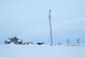 Abandoned weather station in a snow-covered tundra