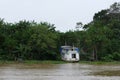 Abandoned white boathouse on the side of the Amazon riverbank, lifestyle at amazonas riverbank