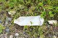 Abandoned plastic bottle in grass. Garbage in nature