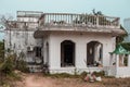 An abandoned white residential house