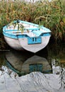 Abandoned wooden boat creates beautiful reflection Royalty Free Stock Photo