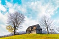 Abandoned wooden house surrounded by bare trees in highland Royalty Free Stock Photo