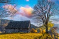 Abandoned wooden house surrounded by bare trees in highland Royalty Free Stock Photo