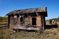 An abandoned wooden old house. Broken windows and doors, holes in the roof Royalty Free Stock Photo