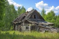 Abandoned wooden old house, desolation and ruin, an old village house among trees In fores