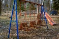 Abandoned woodland playground during wintertime