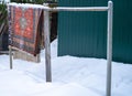 abandoned woolen carpet hanging outdoor, winter scene