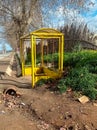 An abandoned yellow bus stop in countryside color