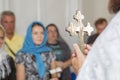 Abbe holding cross in baptism christening ceremony in church