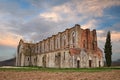 Abbey of Saint Galgano in Chiusdino, Siena, Tuscany, Italy. View at sunset of the medieval roofless church in ruins Royalty Free Stock Photo