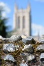 Abbey wall ruins in focus with blurred Catherdral