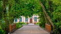 Abbots Palace in the rococo style and located in Oliwa Park in spring scenery with bridge and gree leaves. Royalty Free Stock Photo