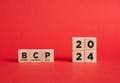 The abbreviation BCP business continuity plan for the year 2024 on wooden cubes with red background Royalty Free Stock Photo