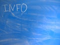 Abbreviation INFO written on a blue, relatively dirty chalkboard by chalk. Located in the upper left corner of the image making
