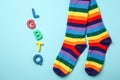 Abbreviation LGBTQ with rainbow socks on color background