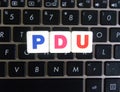 Abbreviation PDU on keyboard background Royalty Free Stock Photo