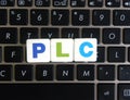 Abbreviation PLC on keyboard background Royalty Free Stock Photo