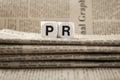 Abbreviation PR on newspapers