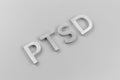 An abbreviation PTSD - post traumatic stress disorder - laid with silver metal letters on light gray flat surface