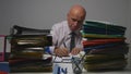 Businessman in Archive Room Signing Accounting Documents