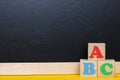 ABC blocks next to a blackboard. Back to school. English for beginners. Empty space for text Royalty Free Stock Photo