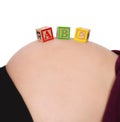 ABC blocks resting on bare pregnant belly Royalty Free Stock Photo