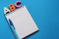 ABC-the first letters of the English alphabet on a blue background. Notebook and pen. Empty space for text. Learn foreign Royalty Free Stock Photo