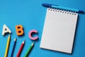 ABC-the first letters of the English alphabet on a blue background. Notebook and pen. Empty space for text. Learn foreign Royalty Free Stock Photo