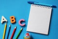 ABC-the first letters of the English alphabet on a blue background. Notebook and pen. Empty space for text. Learn foreign Royalty Free Stock Photo