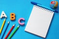 ABC-the first letters of the English alphabet on a blue background. Notebook and pen. Empty space for text. Learn foreign Royalty Free Stock Photo