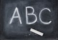 ABC letters and chalk on blackboard Royalty Free Stock Photo