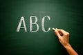 Abc letters with hand and chalk on blackboard Royalty Free Stock Photo