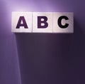 ABC letters wooden blocks on purple. Education concept Royalty Free Stock Photo