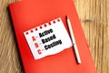 ABC method abbreviation for activity-based costing written on torn paper with red notebook and pen on wooden desk Royalty Free Stock Photo