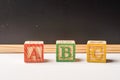 ABC Wooden blocks against chalkboard Royalty Free Stock Photo