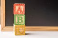 ABC Wooden blocks against chalkboard Royalty Free Stock Photo