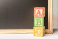 ABC Wooden blocks against chalkboard Royalty Free Stock Photo