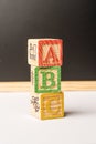 ABC Wooden blocks against chalkboard Royalty Free Stock Photo