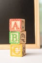 ABC Wooden blocks against chalkboard Royalty Free Stock Photo