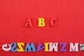 ABC word on red background composed from colorful abc alphabet block wooden letters, copy space for ad text. Learning english Royalty Free Stock Photo