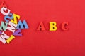 ABC word on red background composed from colorful abc alphabet block wooden letters, copy space for ad text. Learning english Royalty Free Stock Photo