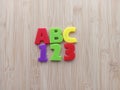 Abc 123 written with colorful letters on a wood background Royalty Free Stock Photo