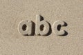 Abc written in sand letters.