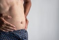 Abdomen of Asian man. Concept of central obesity, belly fat, abdominal bloating or fullness