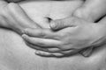 The abdomen of a woman after several months after childbirth, the baby`s legs on the belly, black and white photo Royalty Free Stock Photo