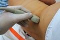 Abdominal convex ultrasound probe held in left hand scanning female kidney