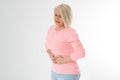 Abdominal pain. Middle aged woman with stomach pain. Menopausal woman with stomach-ache. Healthy and happy menopause lifestyle.